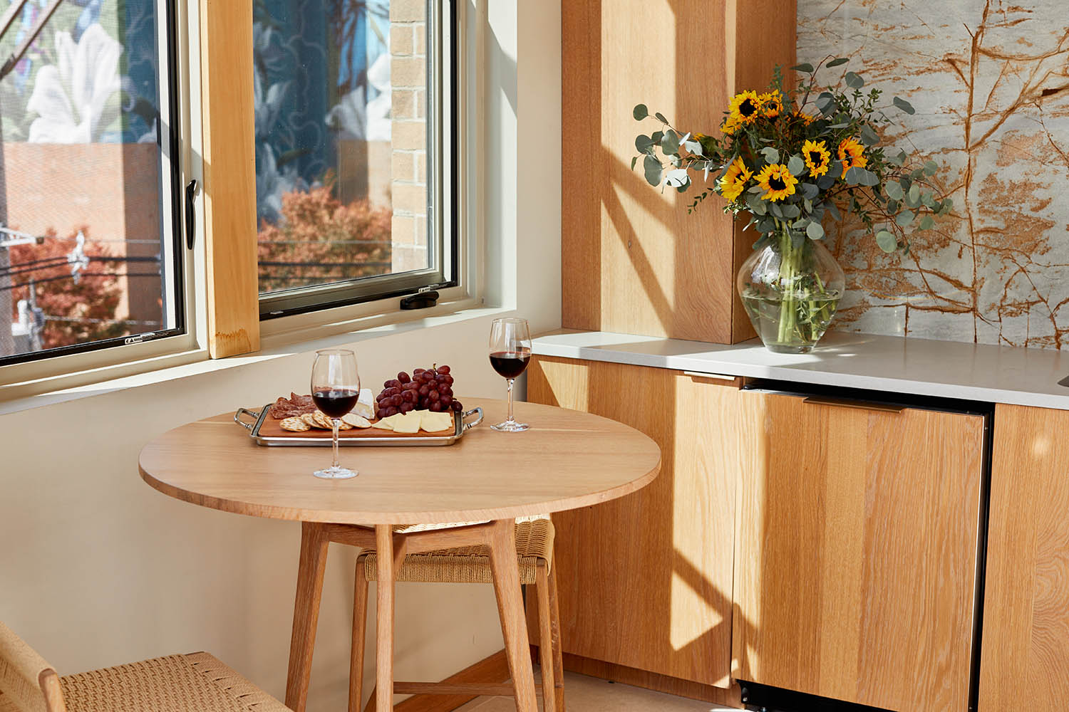 A kitchen with a table and chairs and a window.