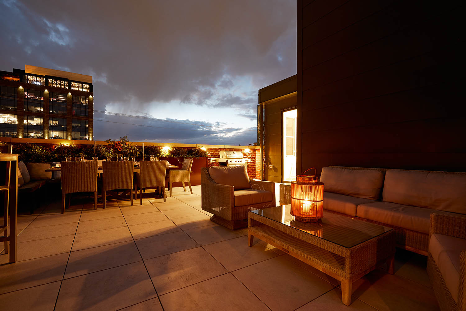 A patio with a table and chairs and a candle.