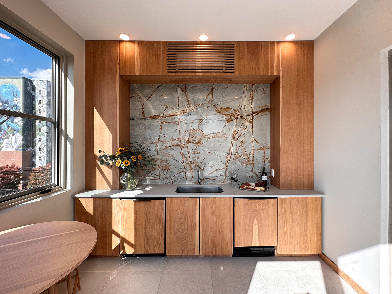 A kitchen with wood cabinets and a window.