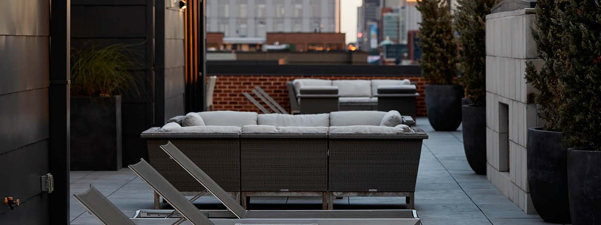 A patio with chairs and a table in front of a building.