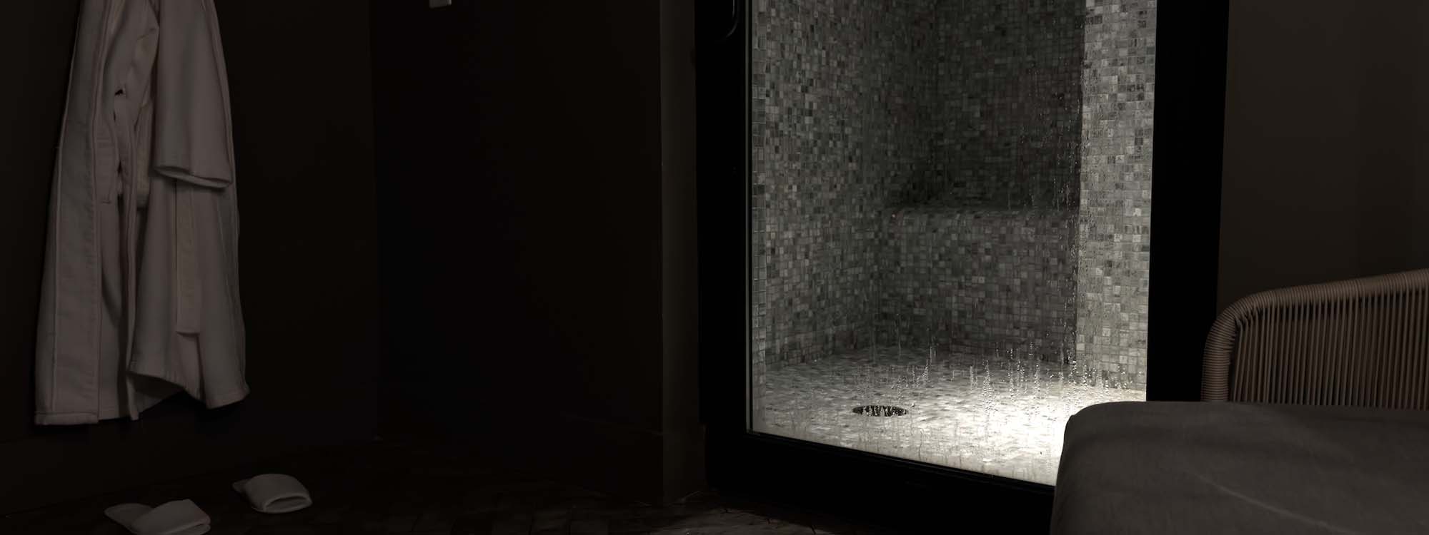 A bathroom with a glass shower door.