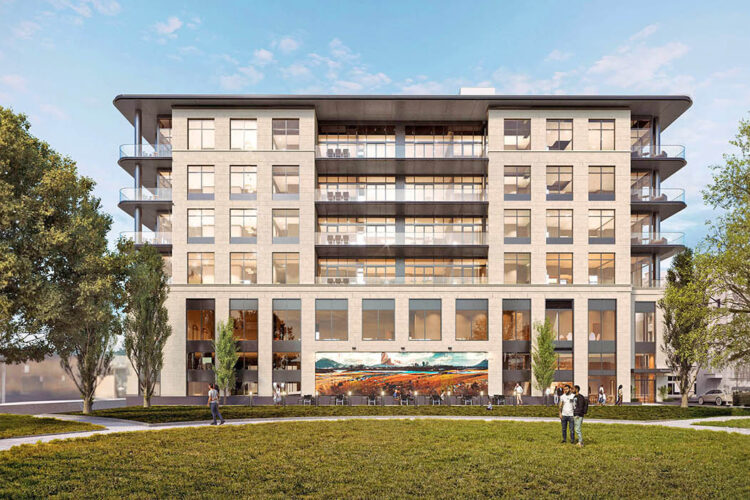 A modern six-story apartment building with large windows, surrounded by trees and grass, under a clear blue sky. People walk and gather on the lawn in front.